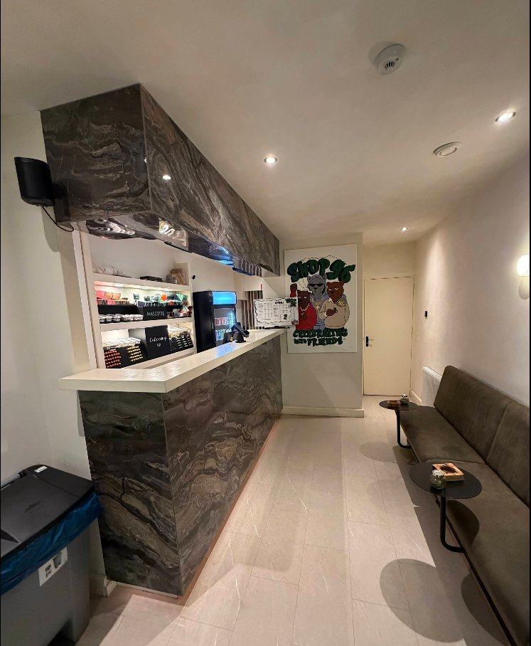 Interior lounge of Coffeeshop 96 with dark marble counter and brown leather seating